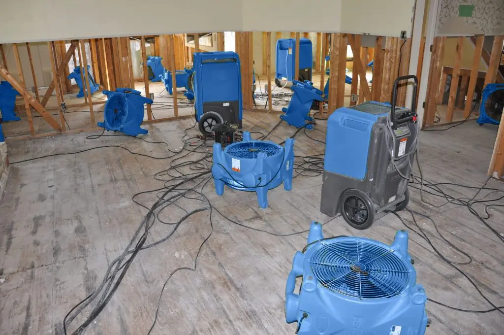 Air movers drying a gutted San Mateo room after major water damage